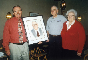 Tom Trevillian presents Woody and Maxine with his portrait when Woody retired for the first time in 1988.