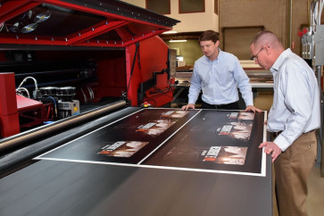 (From left) Stephen Horne, president (Atlanta Division), and Jim Hill, director of operations (Atlanta Division), inspect a job coming off of Drummond&rsquo;s EFI VUTEk HS125 printer. 