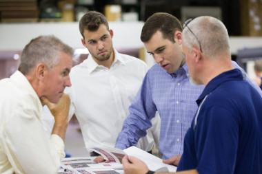 All Color Printers: From left, Billy, Will and Steven Bogue confer about a job with one of All Color&rsquo;s employees.