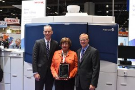 Standing, from the left, is NPES President Thayer Long; GIna Testa, VP, marketing at Xerox Corp.; and Jim Gavitt, VP, Production Color Sales, Xerox.