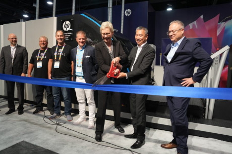 HP Inc. executives cutting the ribbon at PRINTING United Expo 2022 for the new HP PageWide Advantage 2200 inkjet web press included, from the left, Annette Friskopp, GM of PageWide Industrial; Tuan Tran, president of HP Inc. Imaging, Printing & Solutions; and Haim Levit, SVP and GM, HP Industrial Print.