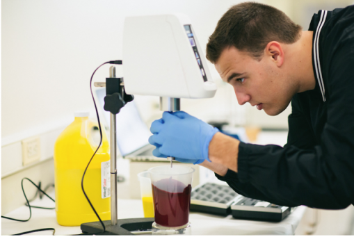 A student in Western Michigan University&rsquo;s Graphic and Printing Science program measures ink viscosity in the program&rsquo;s Ink Lab.
