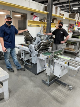 From left: Tony Collins, production manager, and Nick Larsen, bindery operator, both at Peczuh.