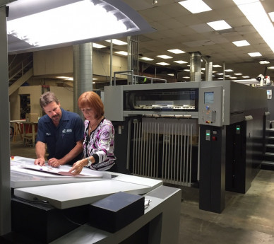 Wayne Yeager, pressman; and Kathy Atkins, president/CEO, of Riegel Communications, review a proof printed on the Speedmaster XL 106-6+L. 