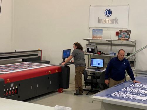 Matt Wagner, department lead, and Joe Dodson, plant manager, oversee work being produced on Linemark&rsquo;s EFI flatbed LED-UV printer and Kongsberg routing table.