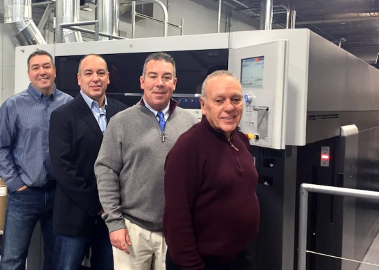 The staff at Paulson Press stand next to the company's newly installed Speedmaster XL 106-4+LYY-P+4+L with UV from Heidelberg. 