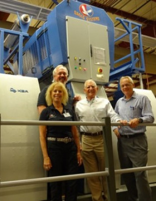 Left to right: Ellen Manning, VP of marketing and sales, Eagle; and Mike King, president, Eagle, are joined by Joe Fenkel, chairman and CEO, McLean Packaging; and Rob Watts, pressroom manager, in front of the Eagle system installed on the company's new KBA 106.