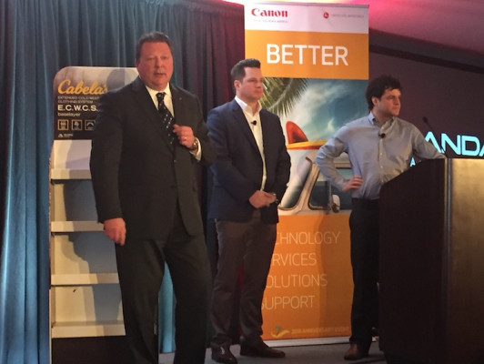 Sal Sheikh (left), vice president of marketing for Large Format Solutions, answers questions with Mark and Matt Landaal of Landaal Packaging Systems.