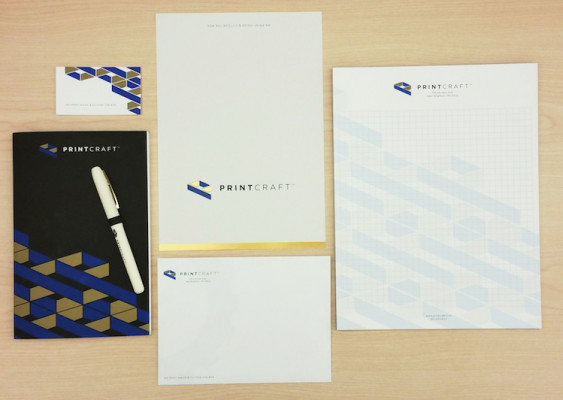 Displayed here are the six components in the folder &mdash; a business card, notepad, notebook, pen, card, and an envelope that displays the company's name and logo.
