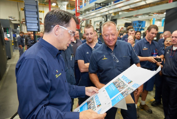Governor Walker looks at digitally printed pages with COO Tom Frankowski.