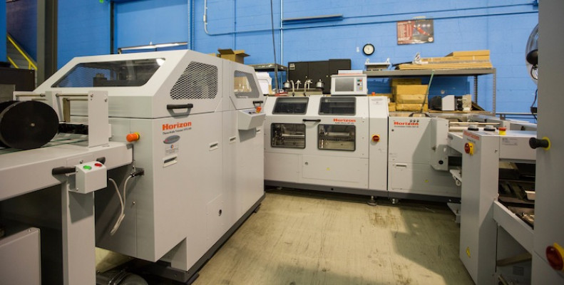 There’s no lack of Standard Horizon finishing gear at Hatteras, including this trimmer, saddle stitcher and accumulator/folder.