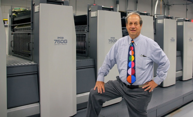 John Rosenthal stands next to the six-color Ryobi 750G offset press with coater that Paradigm Digital Color Graphics installed last year.
