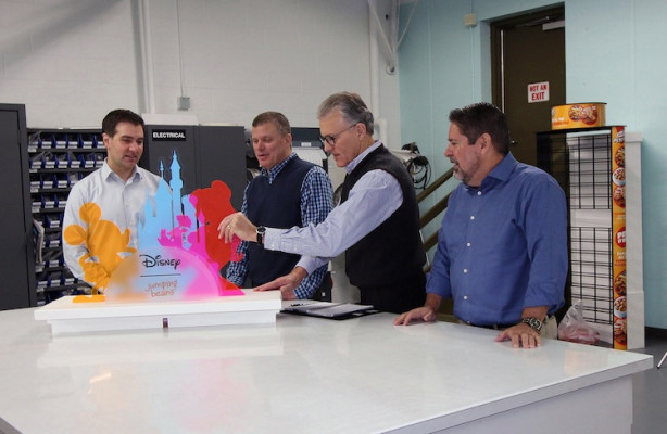 From the left, Christopher Dillon, VP of manufacturing, retail marketing solutions; Glenn Brown, VP creative director; Mike Lane, CEO; and Dave McConnon, VP of manufacturing, Label and Card, take a look at a display that Meyers produced for Disney.