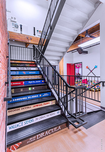These eye-catching book spine stairs were created and installed by Cushing connect the main spaces. Photo by Tim Benson.